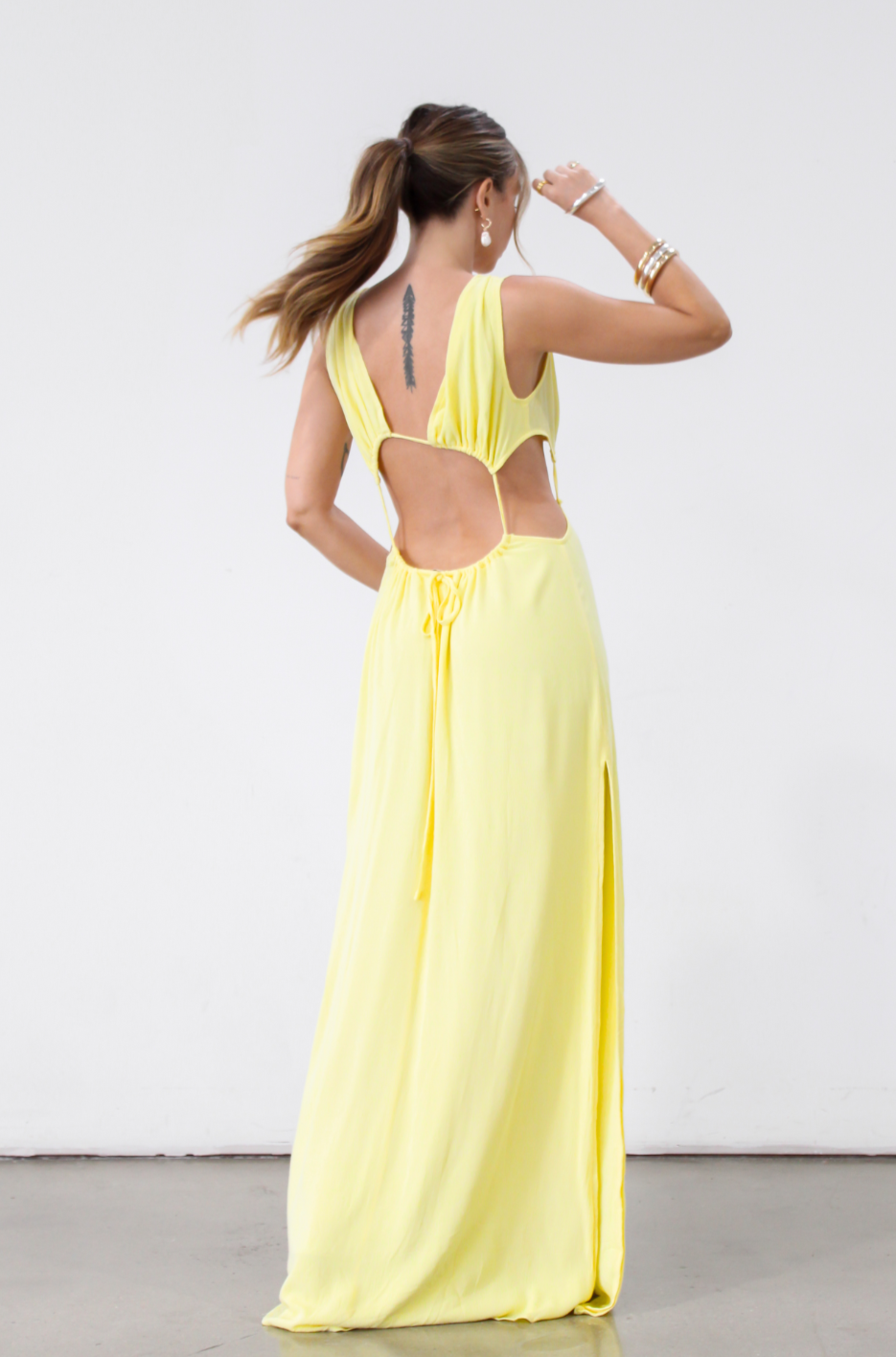 Crinkle woven sleeveless maxi dress. Waist cut outs. Side slits. Back tie closure. Back drawstring waist closure. Partially lined. vacation dress. beach dress. yellow maxi dress. 