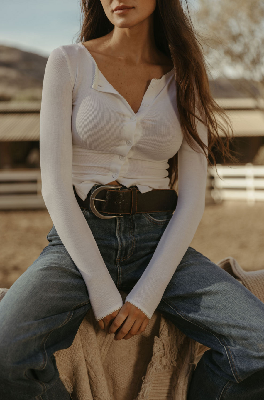 Ribbed knit top. Long sleeves. With elastic sleeve openings. Front button down closures. Unlined. Crochet lace trim. White long sleeve