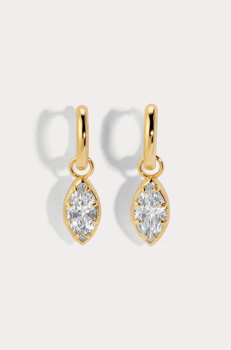 A charmed hoop featuring our most loved marquise cut that catches light with every move
Available in 14kt gold plated brass or Rhodium plated brass
Stones are white cz and measure 10mm x 5.0mm each
Snap Hinge Closure
Sold as a pair
gold cz earrings
fake diamond earrings