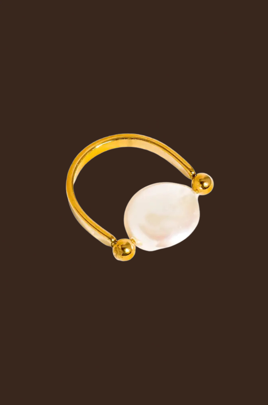 Gold ring with a large pearl
18K Gold Non-Tarnish Baroque Pearl Ring
18K Gold Plating
Stainless Steel
Faux Pearl
Size 7 Measurement: 0.682 Diameter/2.14 Circumference
Lead-free
Nickel-safe
Hypoallergenic
Water Resistant