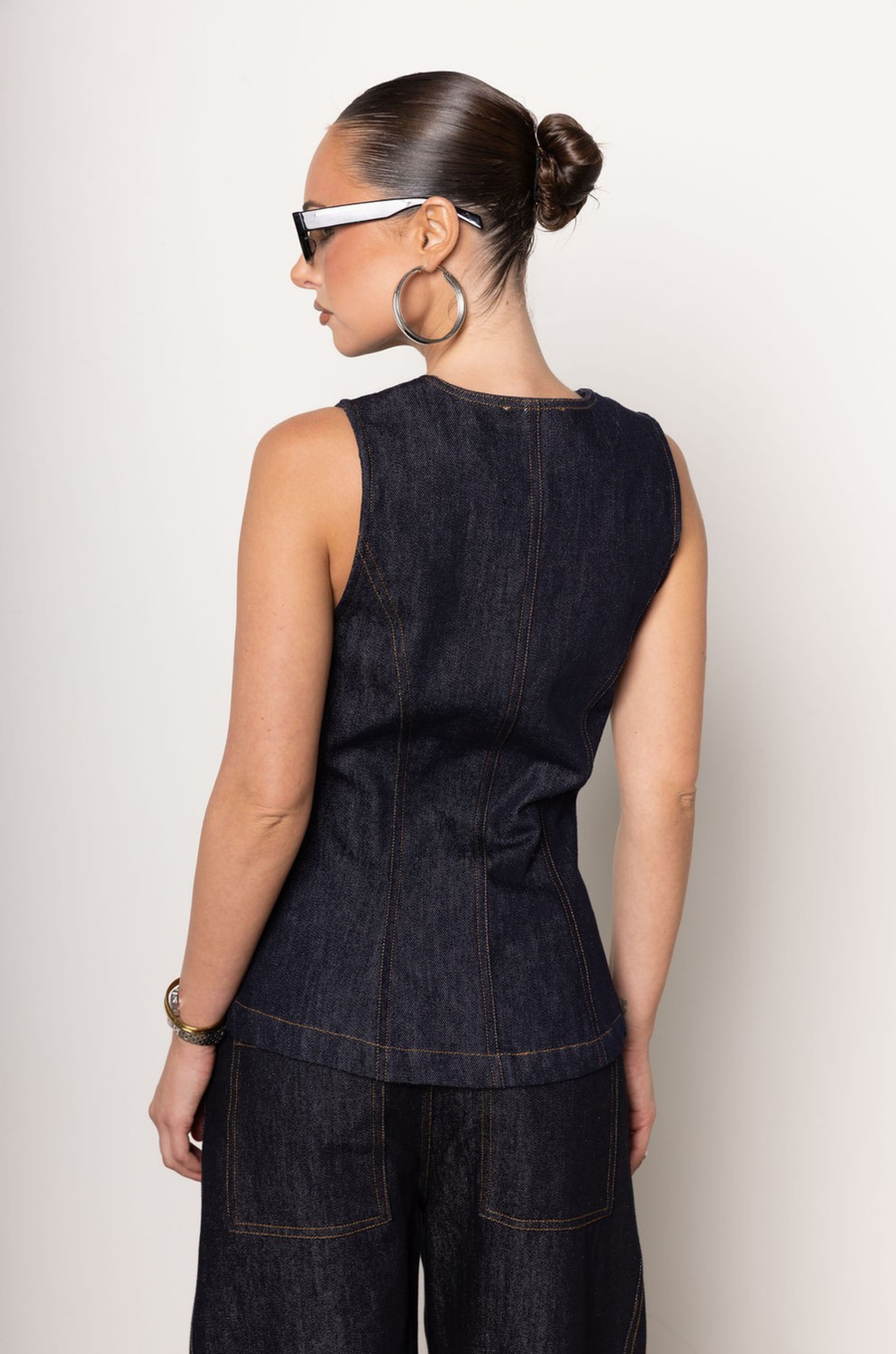 Denim vest top
Button down closure
Sleeveless
Unlined
V cut out at hemline
Length: 24"
Cotton
dark denim top
fall outfit
fall top
denim on denim outfit