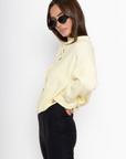 Fuzzy knit cardigan
Crewneck
Front button down closures
Long sleeves
Unlined
yellow cardigan