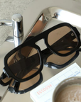 A modern take on a retro classic sunglasses.
Large frame.
Sleek black rims and softly tinted lenses for a lighter, cooler vibe.
Effortlessly stylish and endlessly versatile, they add instant edge to any look—whether you're keeping it casual or turning heads.
black frame sunglasses with brown lens
iris from love island