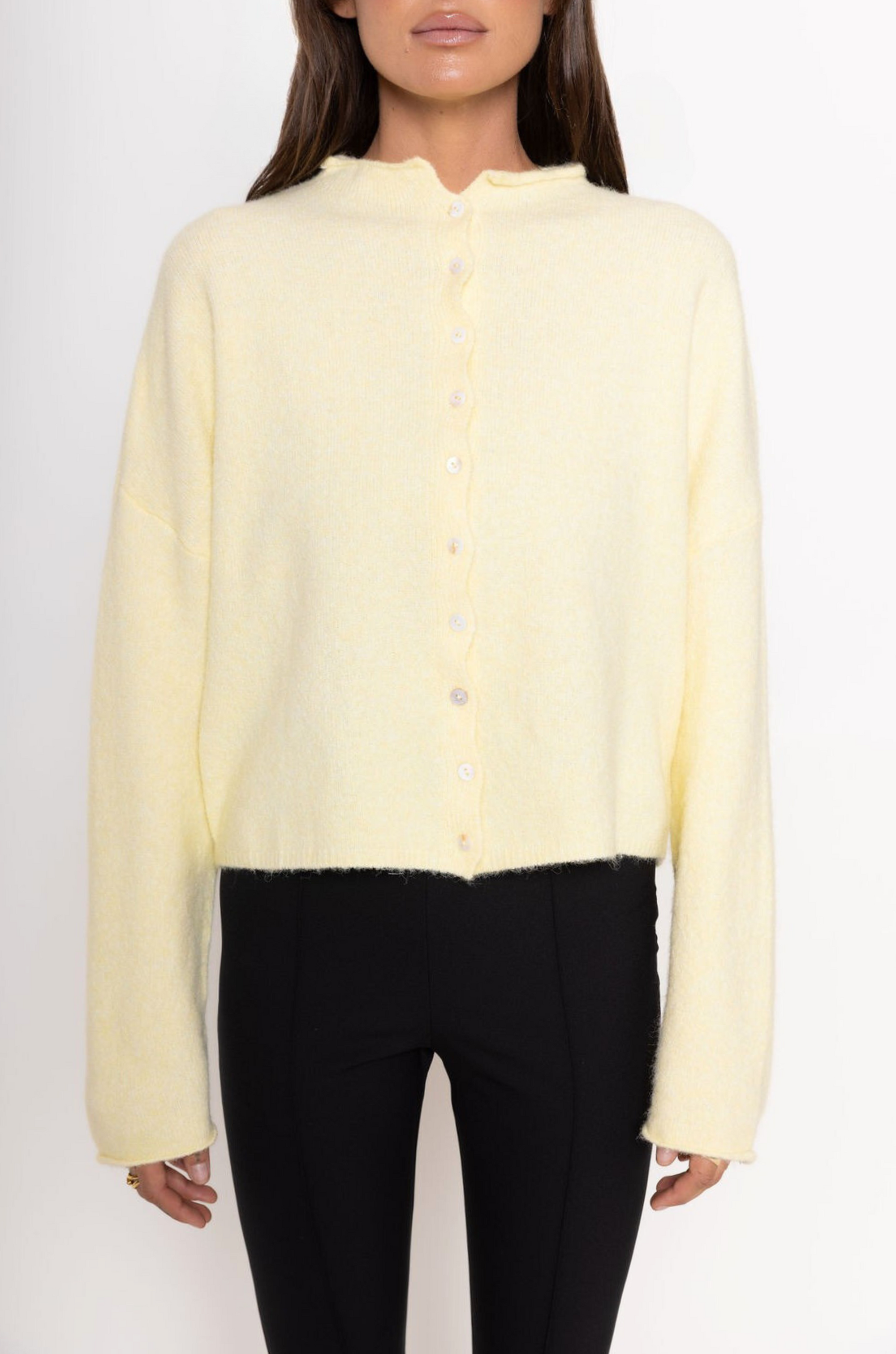 Fuzzy knit cardigan
Crewneck
Front button down closures
Long sleeves
Unlined
yellow cardigan