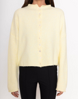 Fuzzy knit cardigan
Crewneck
Front button down closures
Long sleeves
Unlined
yellow cardigan