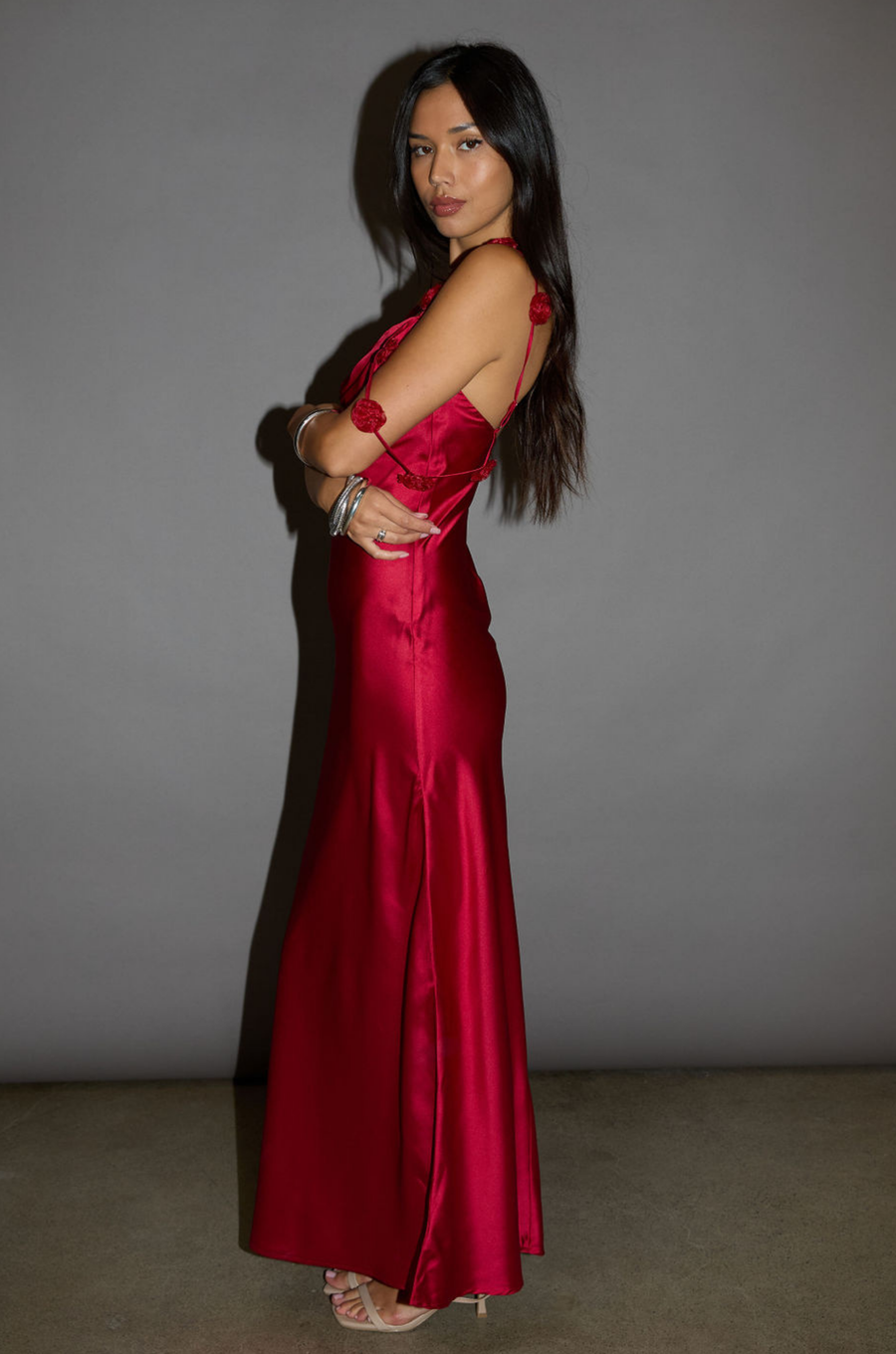 Satin maxi dress. Adjustable straps with rosette details. Side hook and eye and zipper closures. Unlined. red maxi dress. holiday look. holiday inspo. holiday outfit