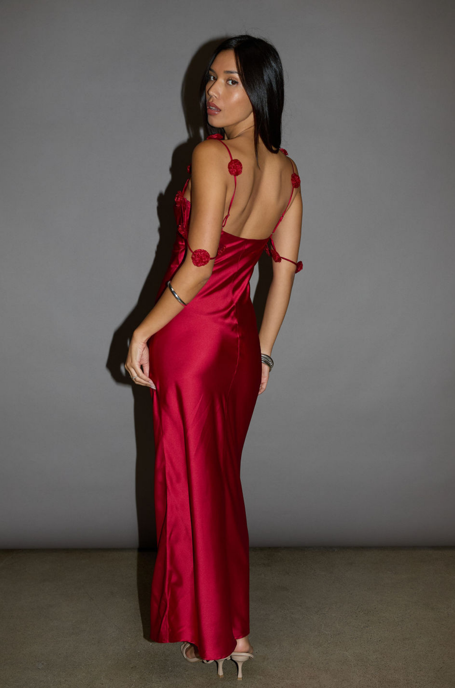 Satin maxi dress. Adjustable straps with rosette details. Side hook and eye and zipper closures. Unlined. red maxi dress. holiday look. holiday inspo. holiday outfit