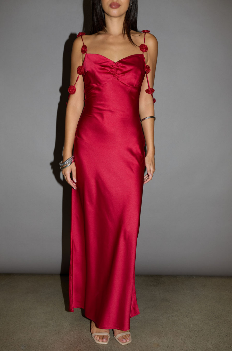 Satin maxi dress. Adjustable straps with rosette details. Side hook and eye and zipper closures. Unlined. red maxi dress. holiday look. holiday inspo. holiday outfit