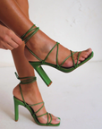 Vegan leather green lace up heel. Open square toe.

high shaved block heel
open square toe
thin flat toe strap
crossover over strappy upper
wrap around lace up ankle strap
exposed heel counter
synthetic upper, lining and outsole
Heel height 10.5cm.