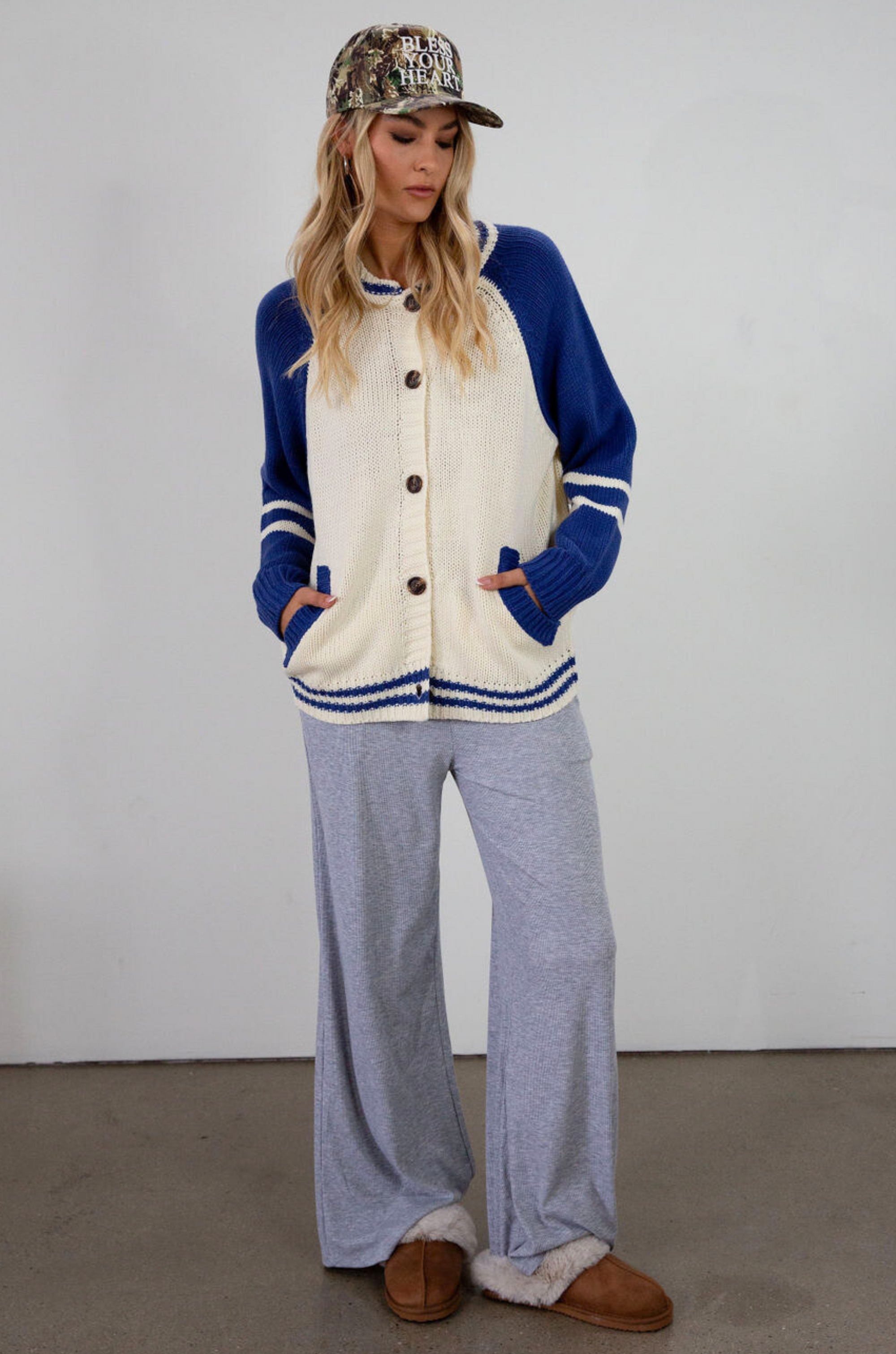 Colorblocked crochet knit cardigan. Crewneck. Long sleeves. Front button down closures. Front pockets. Unlined. ivory and blue sweater cardigan. fall top. fall sweater. oversized sweater