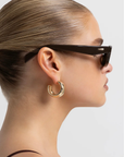 brown Sleek rectangular sunglasses
Featuring a structured silhouette with a bold frame and tonal lenses
Chunky acetate frame