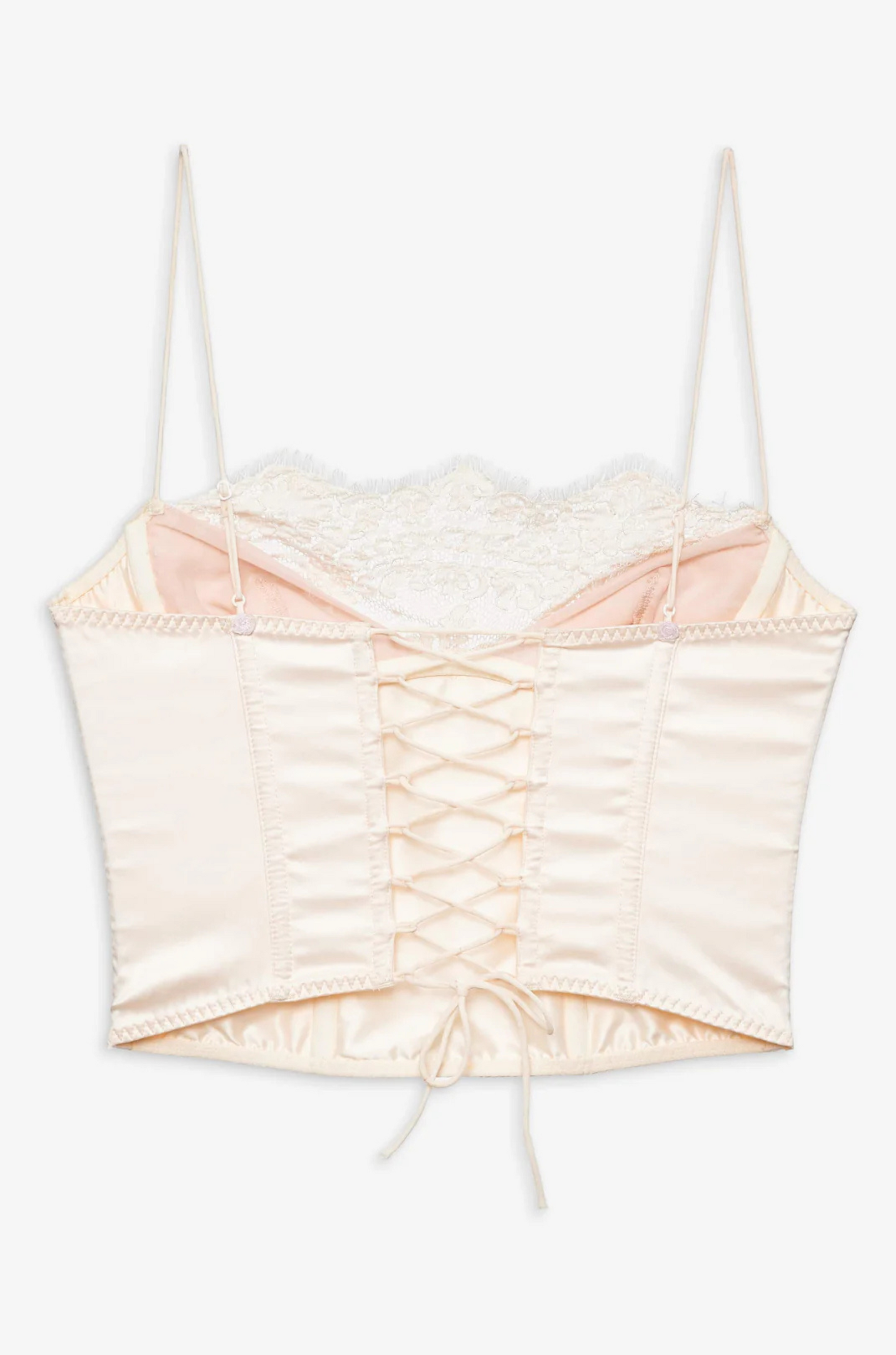 cream Sleek satin bustier with lace detailing
Fully boned bodice
Adjustable lace-up back
Skinny tie bow
Rosette adornments
Lined at cups
Adjustable shoulder straps
Polyester/Elastane
cream ligneire bustier top