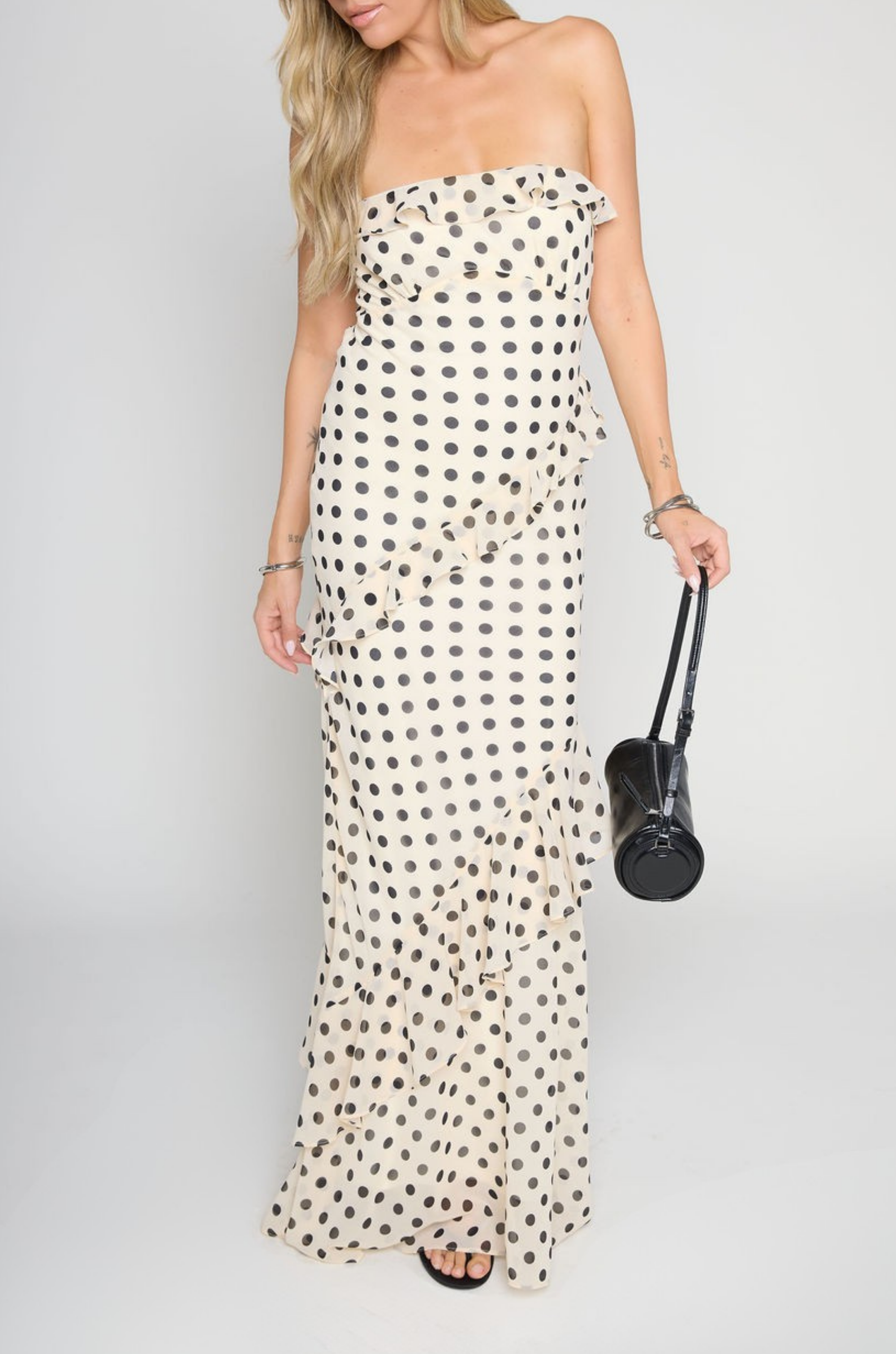 Polka dot printed maxi dress
Tube top
Ruffle on bust trim
Asymmetric ruffle detail on bottom half
Back cut out
Inner rubber grip lining
Side zipper closure
Lined
cream and black polka dot dress
bridal maxi dress