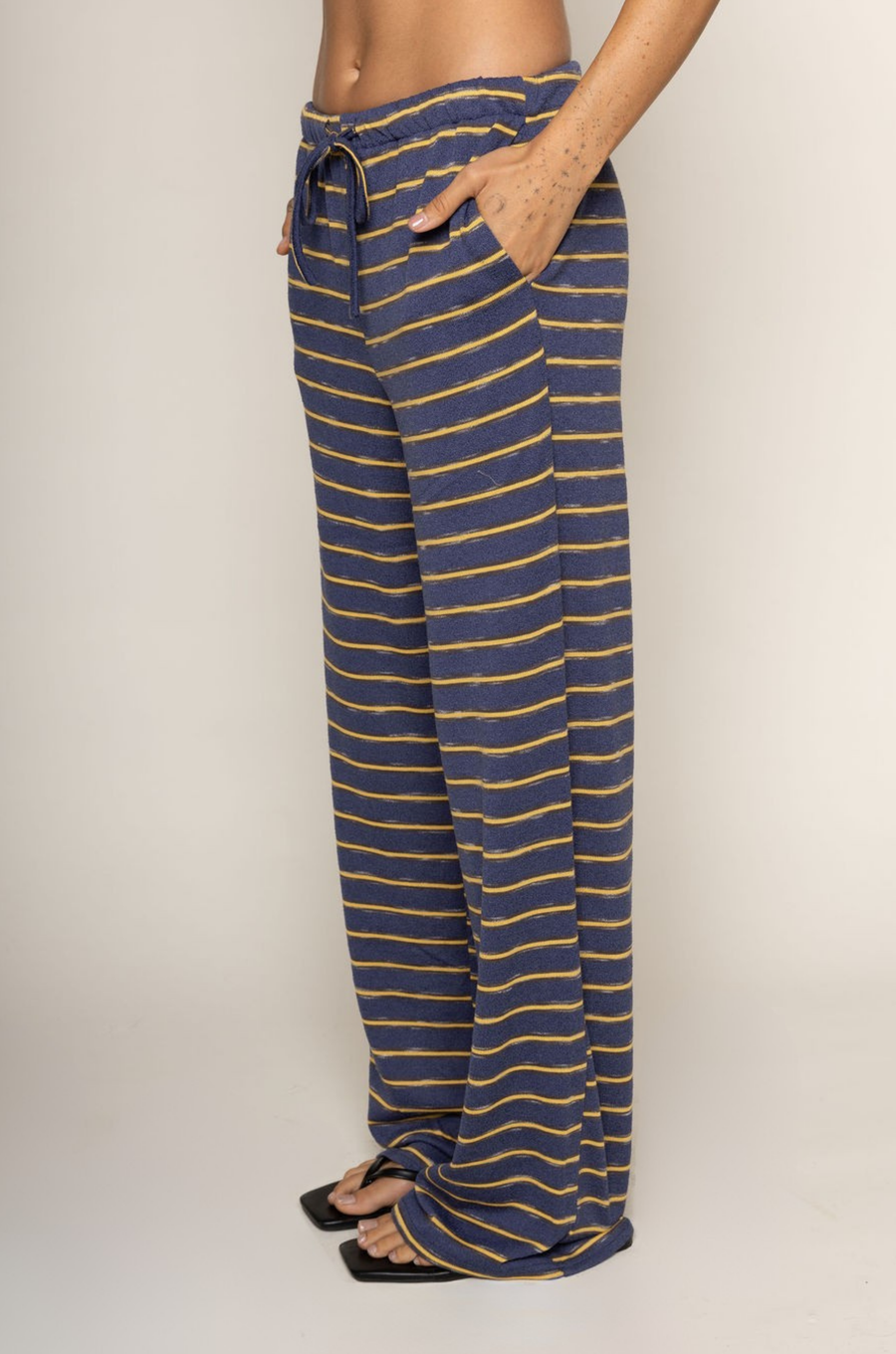 TOP:
blue and yellow Striped knit tube top
Side slits
Rubber grip lining
Unlined

BOTTOM:
blue and yellow Striped knit pants
Elastic waistband
Adjustable waistband tie
Unlined
cute loungewear
beach day outfit
fourth of july cute casual outfit
striped lounge pant set