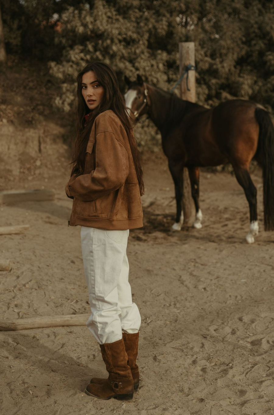 Tan brown faux suede jacket. Front zipper closure. Front and side pockets. Long sleeves with button closures. Fully lined. suede bomber jacket