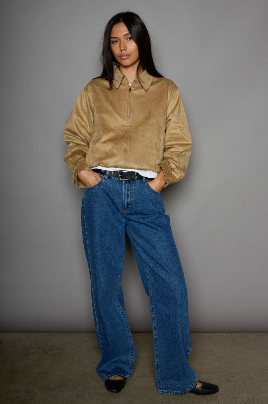 Vegan suede bomber jacket. Collar neckline. Front zipper closure. Elastic hems. Front pockets with snap button closures. Fully lined. tan suede bomber