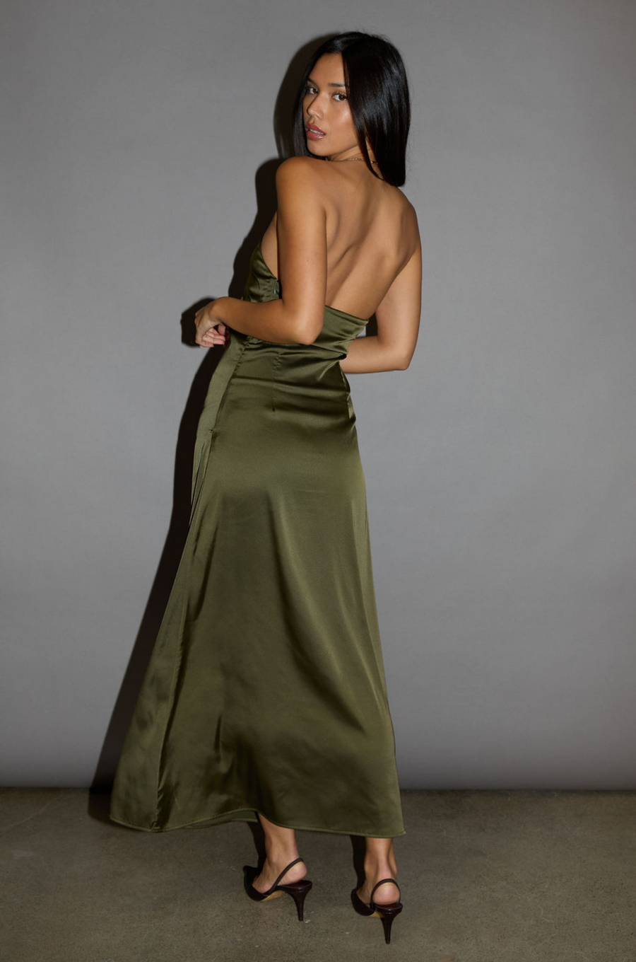 Satin maxi dress. Strapless elastic neckline with inner rubber grip lining. Front wire detail. Side hook and eye and zipper closures. Unlined. olive maxi dress. holiday look. holiday outfit. holiday dress. christmas outfit. christmas dress. new years dress. 