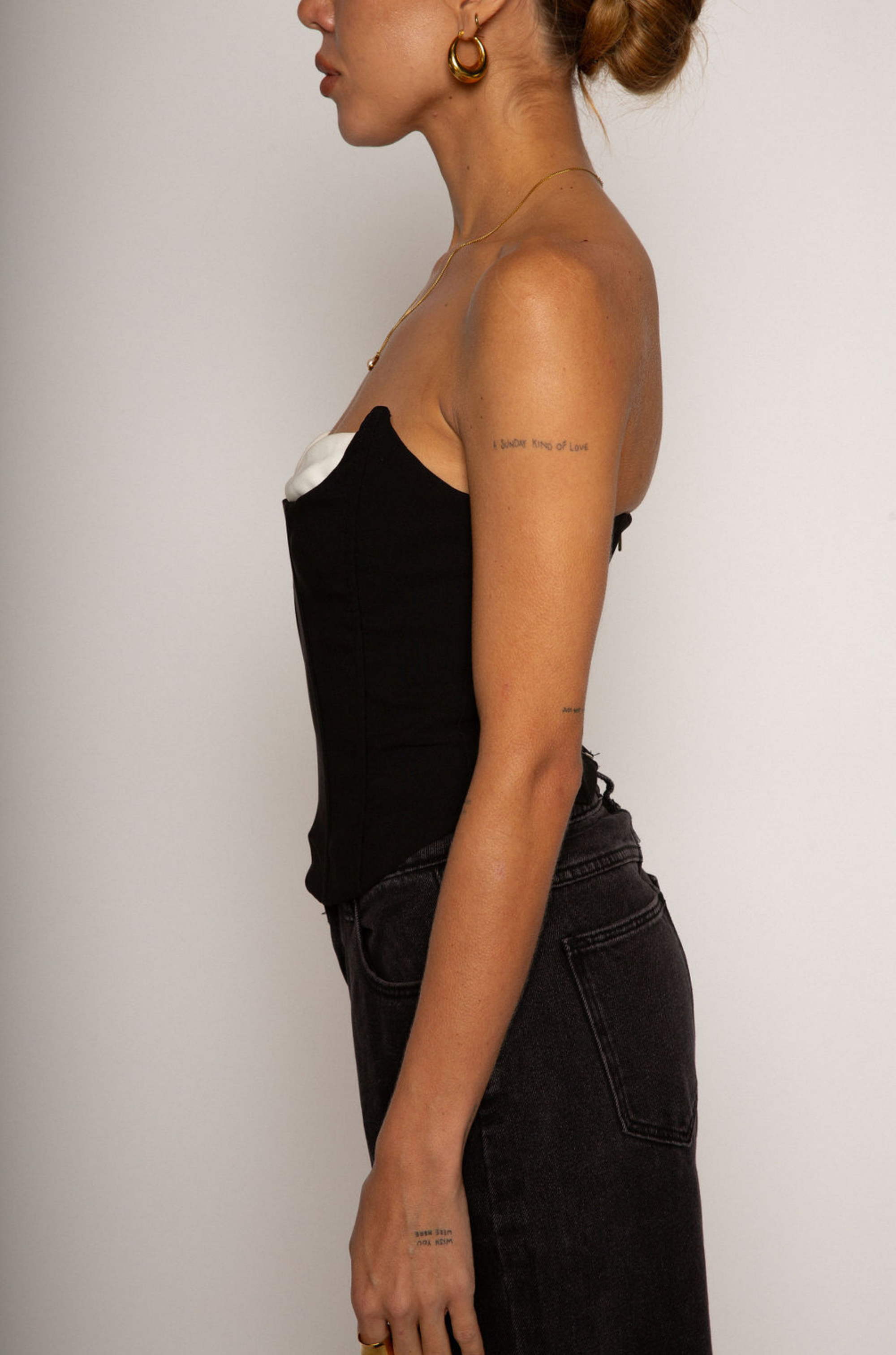 Color blocked woven bustier. Strapless neckline with inner rubber grip lining. Boning in bodice. Back hook and eye and zipper closures. Fully lined. black corset. going out top