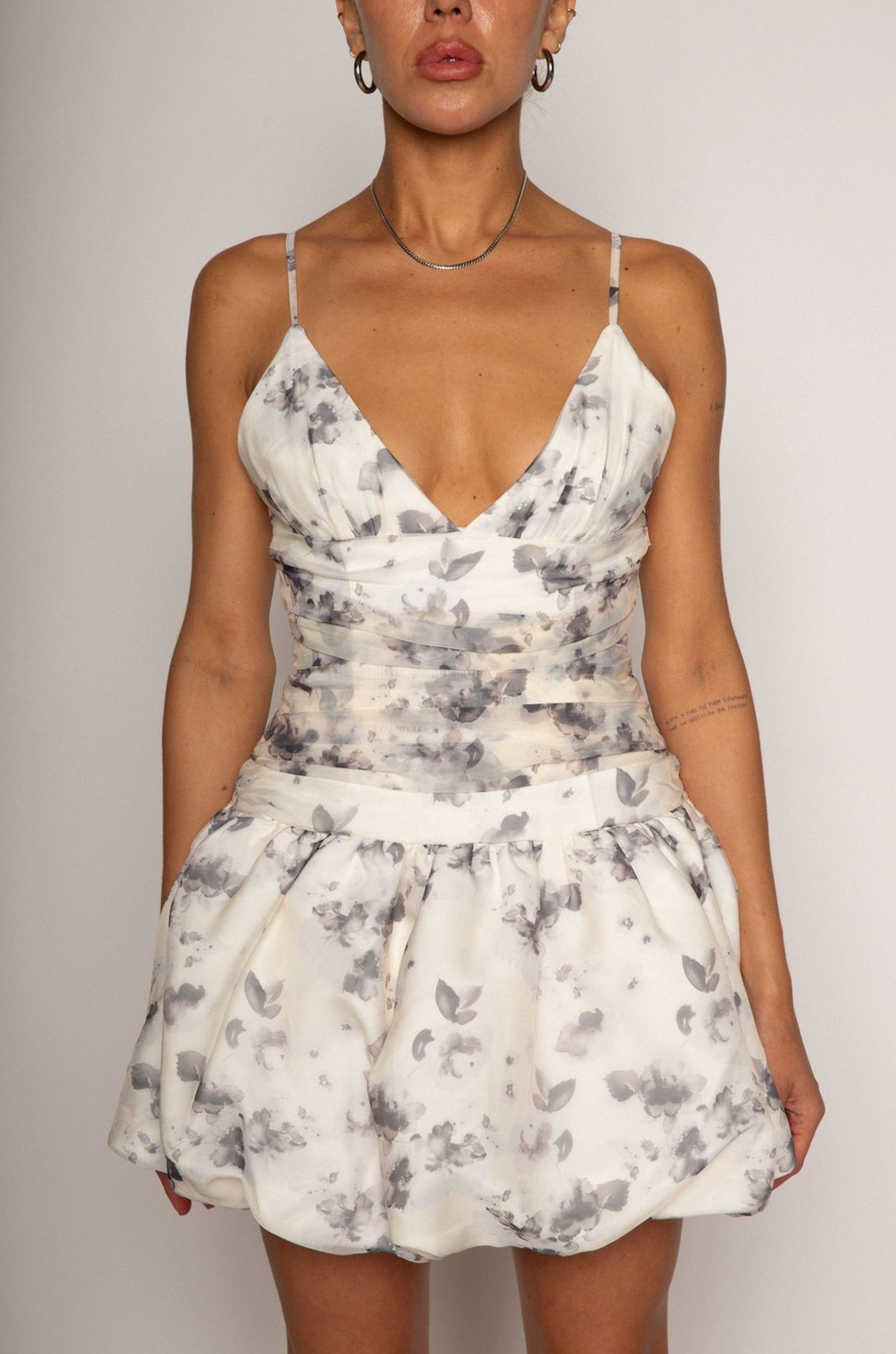Floral printed woven dress. Adjustable straps. Ruched bodice. Bubble hem with elastic opening. Back hook and eye and zipper closures. Fully lined. bridal dress. bridal. bride. white mini bubble dress.