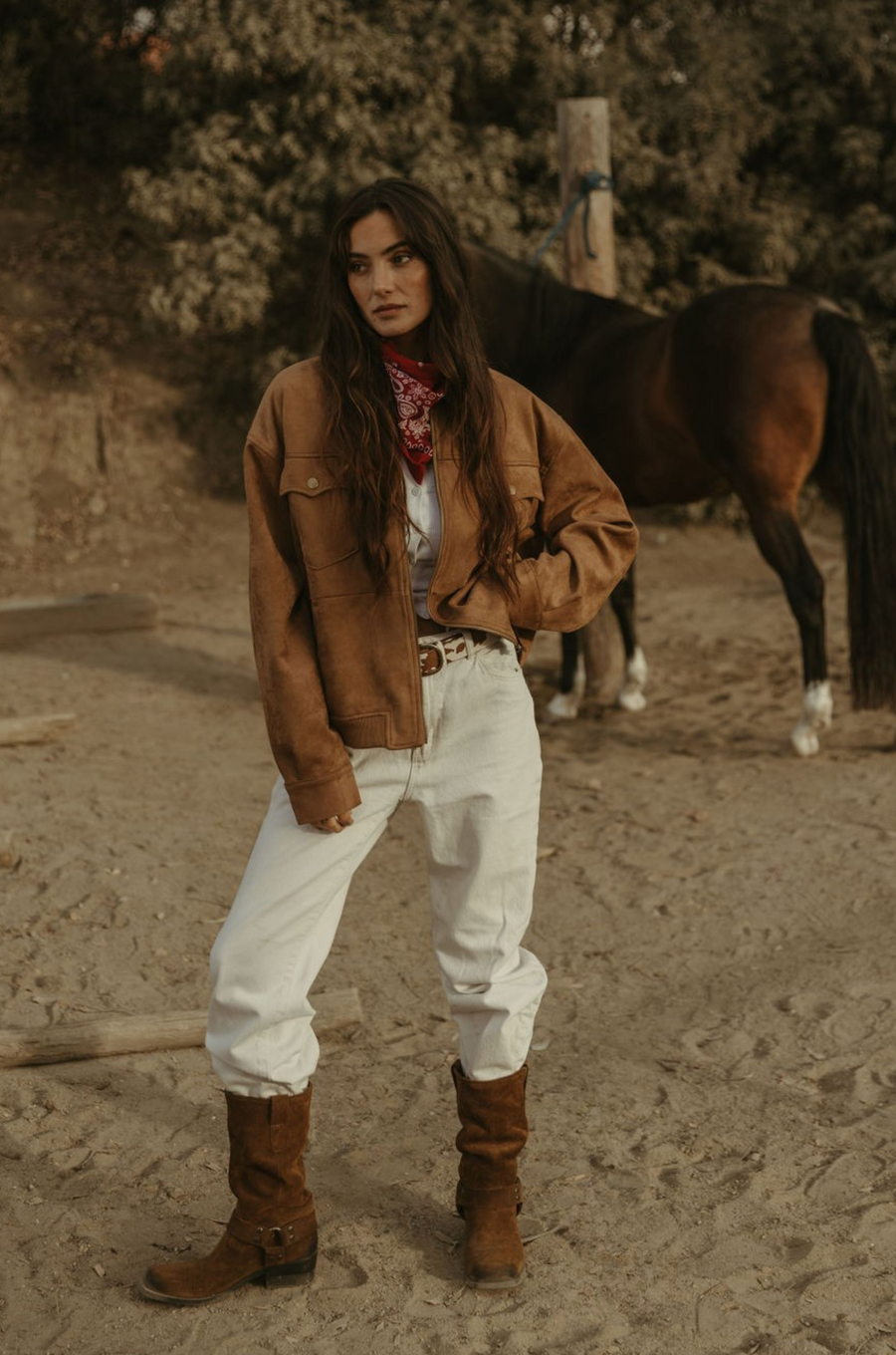 Tan brown faux suede jacket. Front zipper closure. Front and side pockets. Long sleeves with button closures. Fully lined. suede bomber jacket