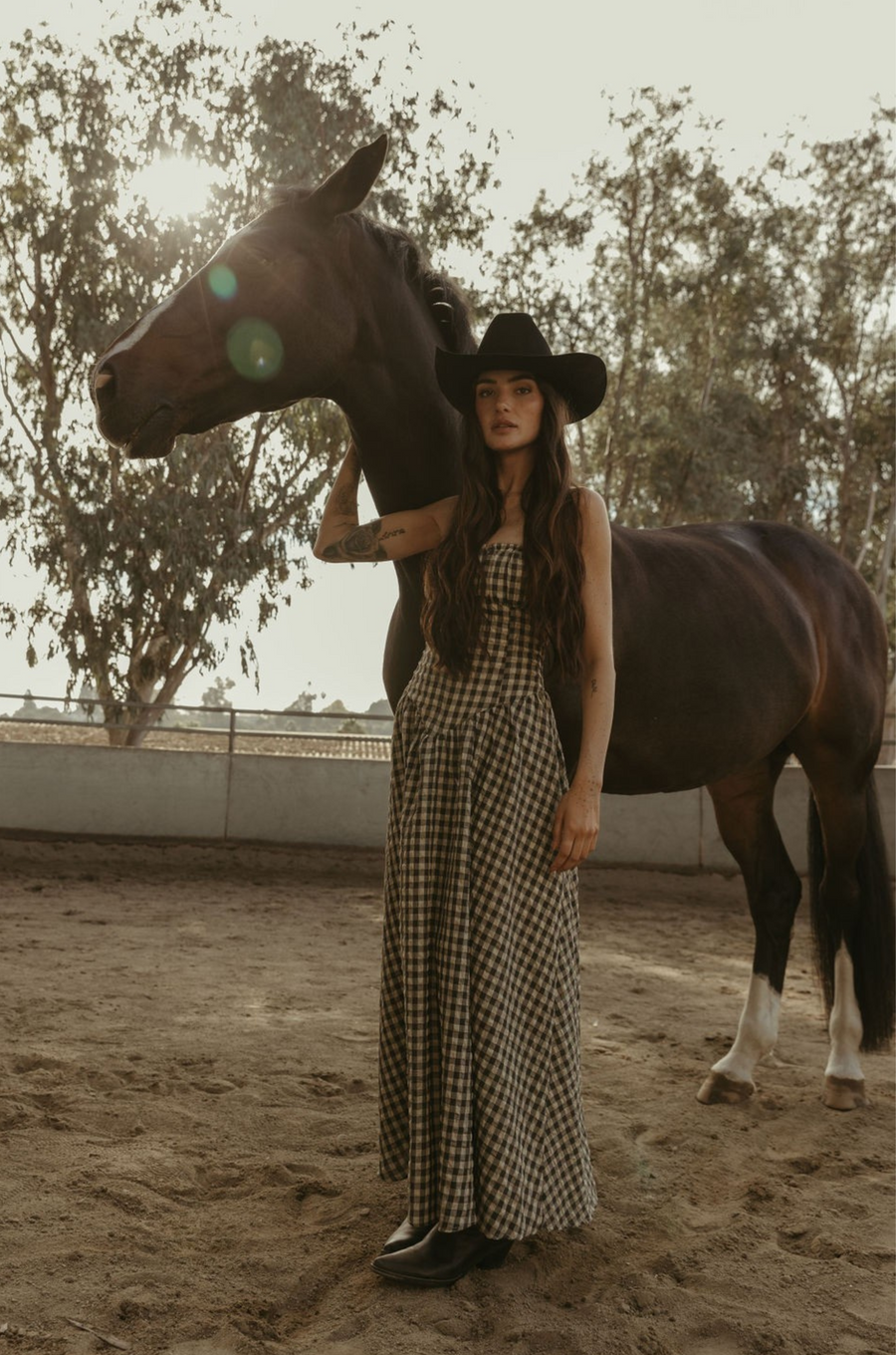 Plaid woven maxi dress. Elastic strapless neckline. Inner rubber grip lining. Elastic smocked back panel. Back hook and eye and zipper closures. Fully lined. Paid maxi dress. ranch outfit. western outfit