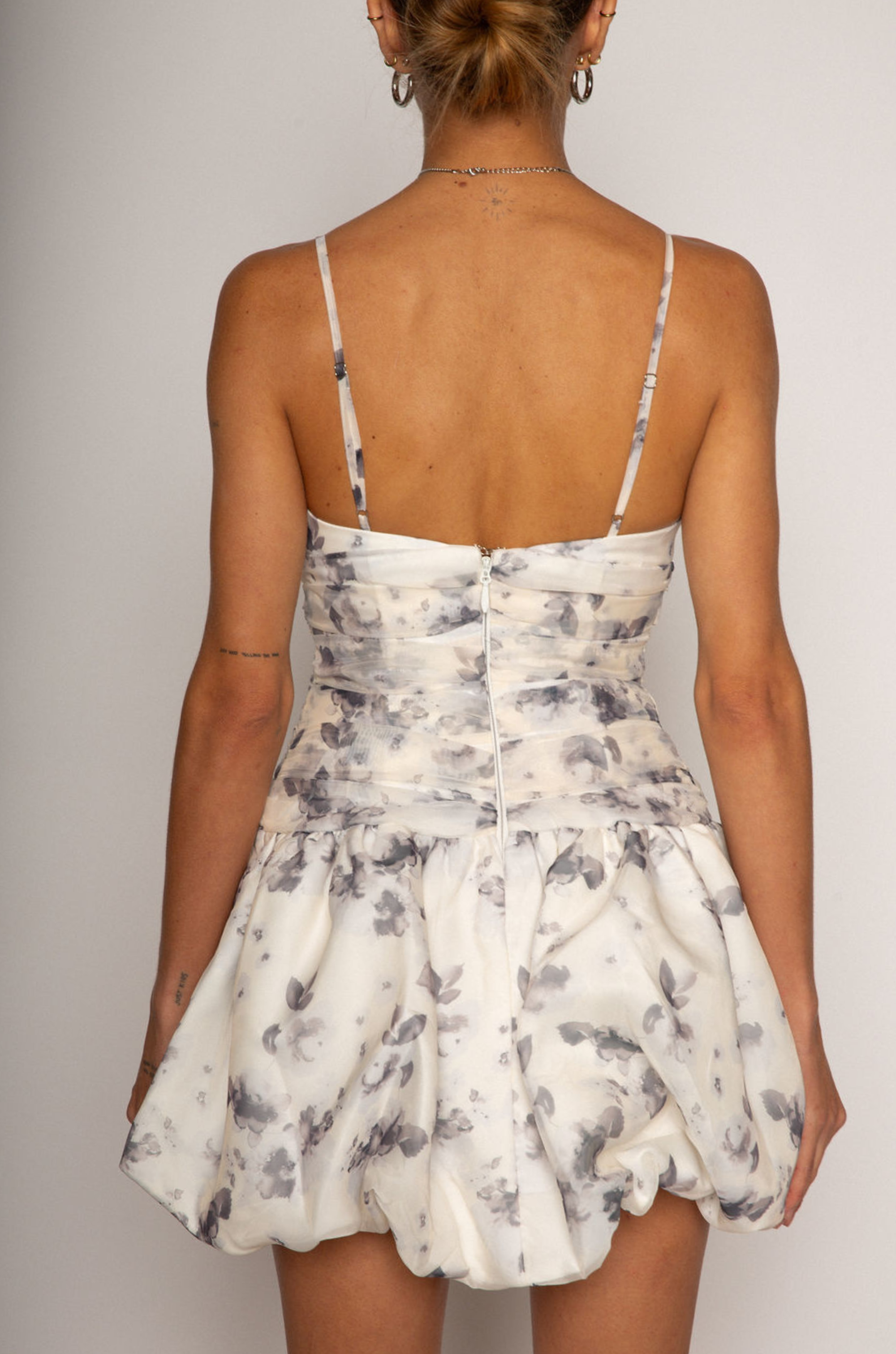Floral printed woven dress. Adjustable straps. Ruched bodice. Bubble hem with elastic opening. Back hook and eye and zipper closures. Fully lined. bridal dress. bridal. bride. white mini bubble dress.