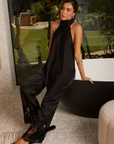 black Satin halter top
Adjustable neck tie
V asymmetrical hemline
Back strap
Open back
Unlined