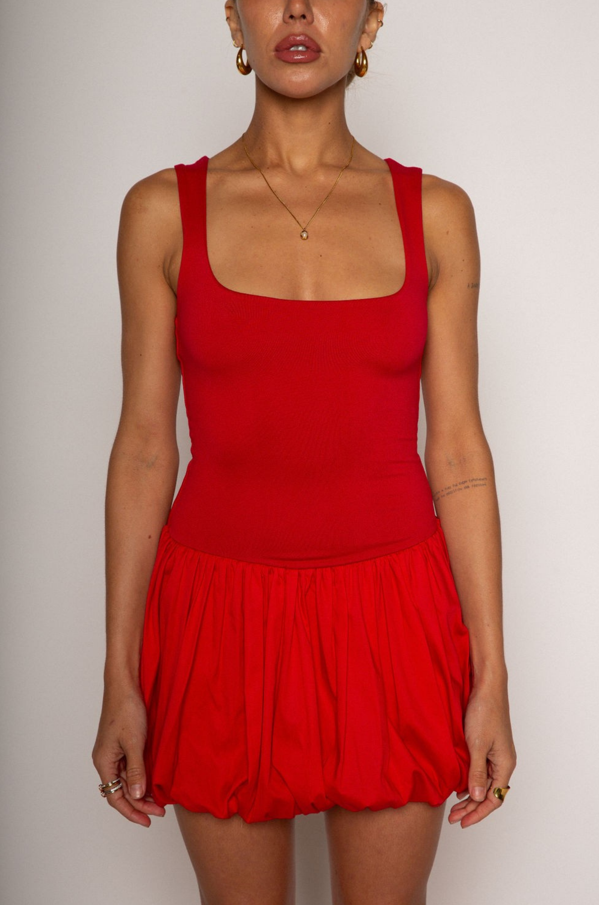 Sleeveless dress. Knit bodice. Woven bubble skirt. Elastic hem. Fully lined. red mini dress. red mini bubble dress. bubble dress. summer dress. night out dress. going out dress. date night dress