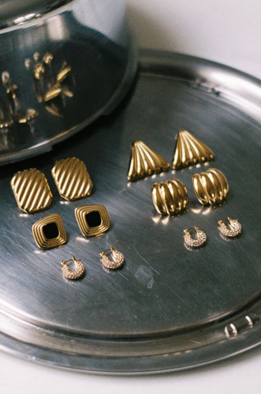 Tiny gold hoops
Featuring a row of dainty diamond-like stones
Made from waterproof, tarnish-free materials, they’re built to shine through workouts, showers, and summer heat