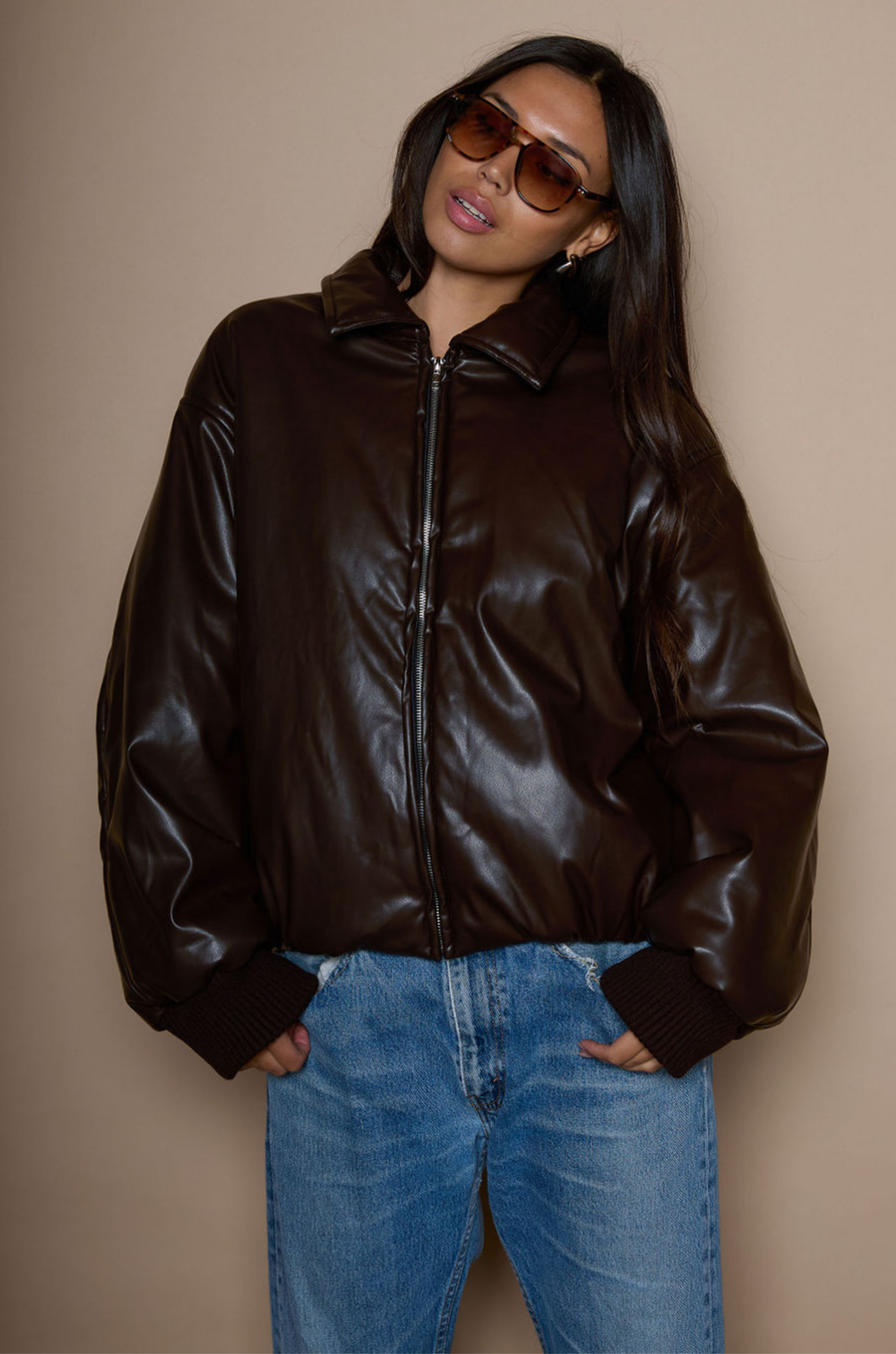 Faux leather jacket. Collar neckline. Long sleeves with elastic openings. Front zipper closures. Side pockets with snap button closure. Elastic hem. Fully lined. brown puffer jacket. brown puffer bomber jacket. fall jacket. bomber jacket. going out jacket