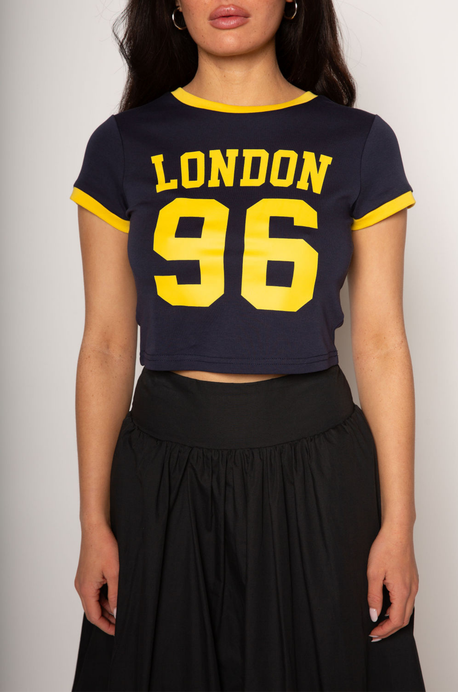 Graphic printed knit crop ringer tee. Crewneck. Short sleeves. Unlined. london graphic tee. baby crop tee