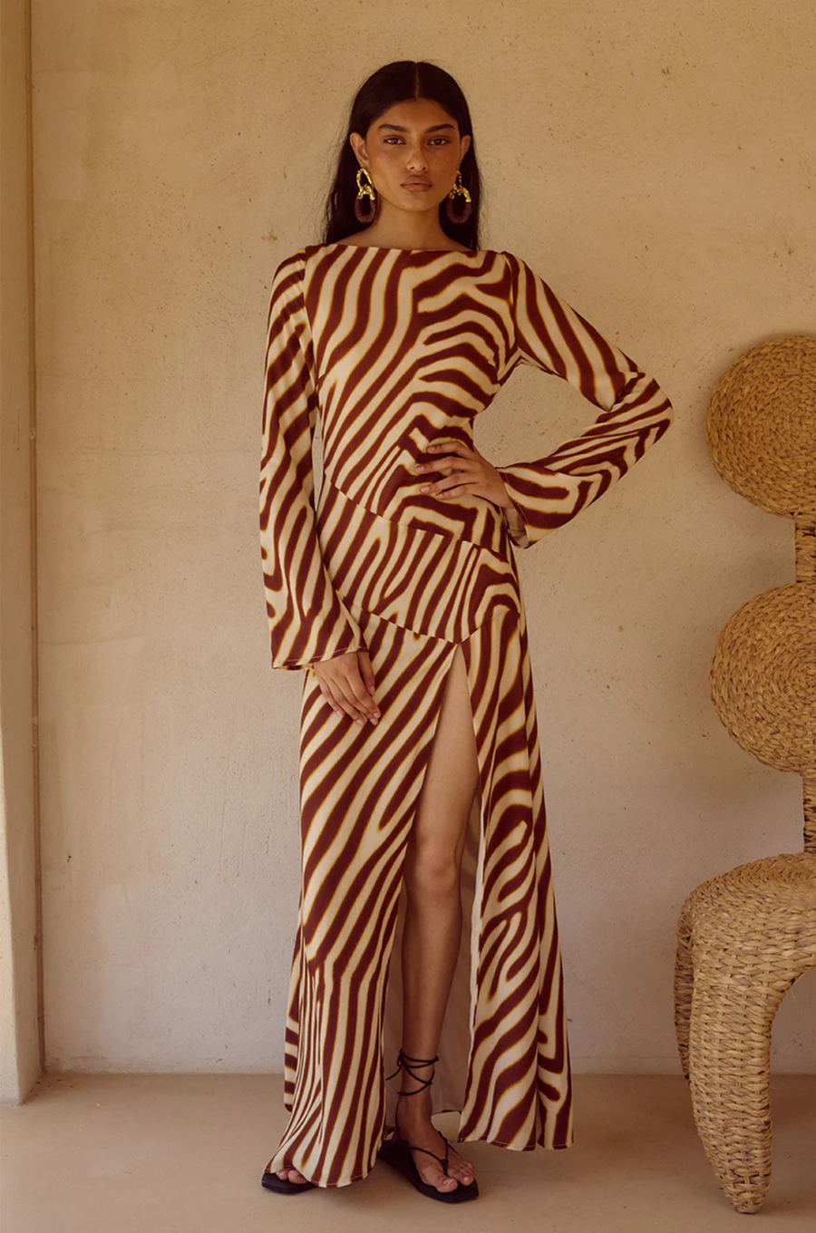 Animal printed long sleeve maxi dress
Front high slit 
Boat neckline
Adjustable back straps 
Open back Back zipper closure 
Lined, non-stretch 
zebra printed maxi dress 
long sleeve maxi dress