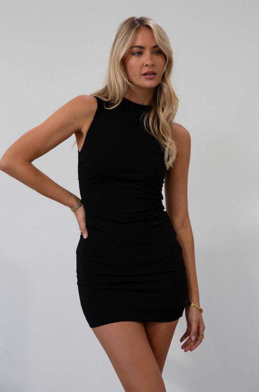 Sleeveless knit dress. Mock neck. Ruched sides. Fully lined. black mini dress. black mock neck mini dress. fall dress. fall outfit