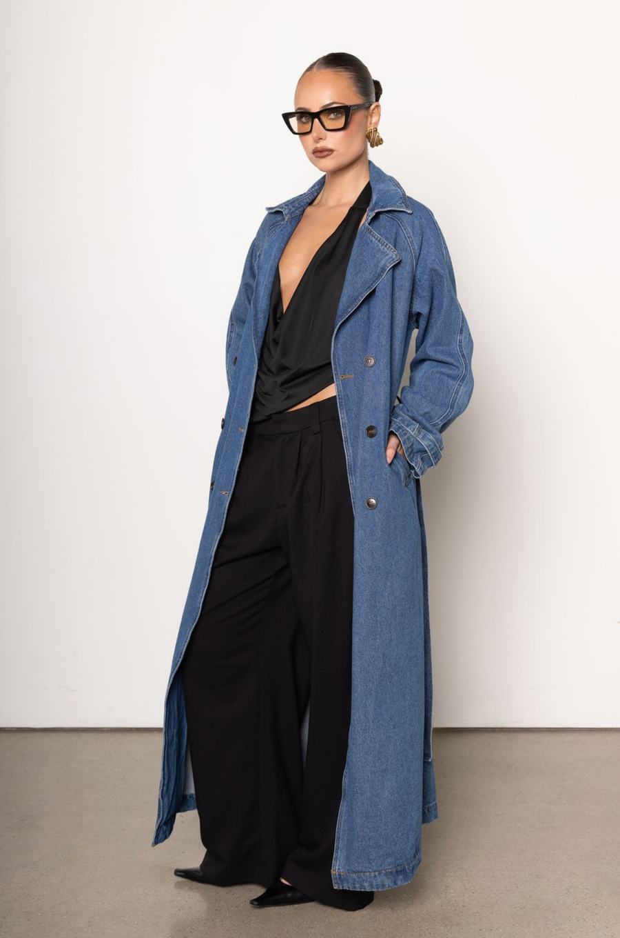 Denim long line trench coat
Adjustable and removable belt
Double breasted button down closure
Unlined
blue denim trench coat