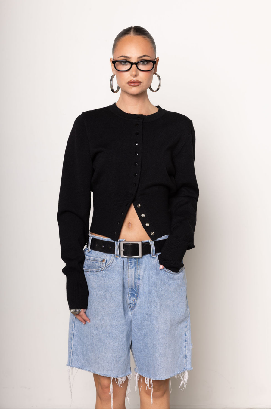 Black knit cardigan. Long sleeves. Front button down closure. Banded hems. Unlined. fall top. fall outfit. holiday outfit.