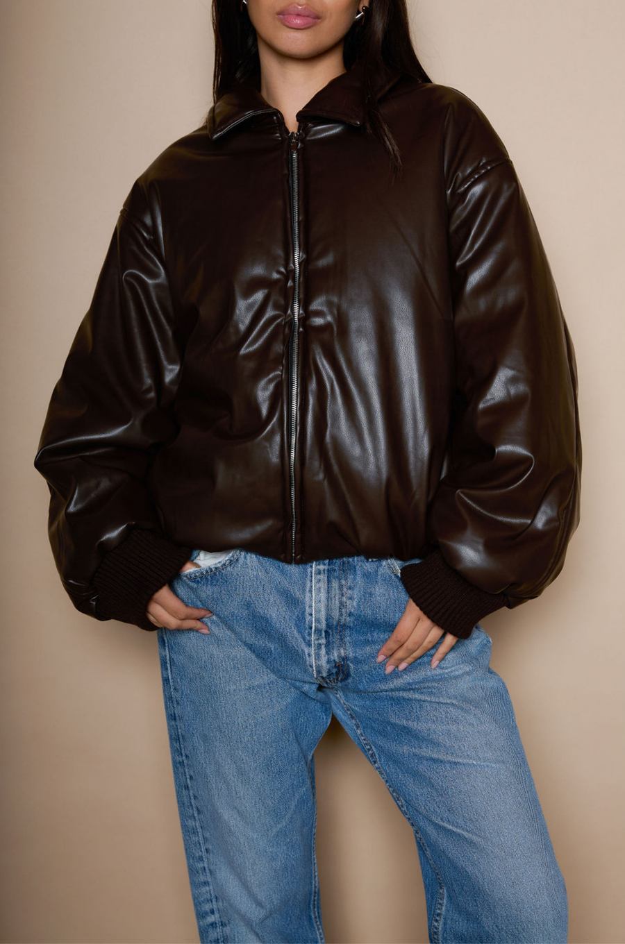 Faux leather jacket. Collar neckline. Long sleeves with elastic openings. Front zipper closures. Side pockets with snap button closure. Elastic hem. Fully lined. brown puffer jacket. brown puffer bomber jacket. fall jacket. bomber jacket. going out jacket