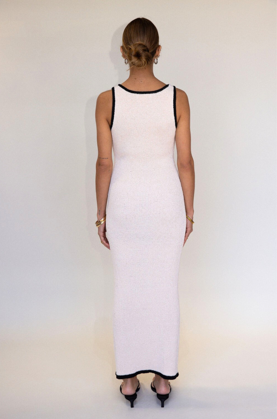 cream Crochet knit maxi dress. Sleeveless. V-neckline. Front button down closures. Faux front pockets. Unlined. cream knit maxi dress. knit button down maxi dress