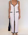 cream Crochet knit maxi dress. Sleeveless. V-neckline. Front button down closures. Faux front pockets. Unlined. cream knit maxi dress. knit button down maxi dress