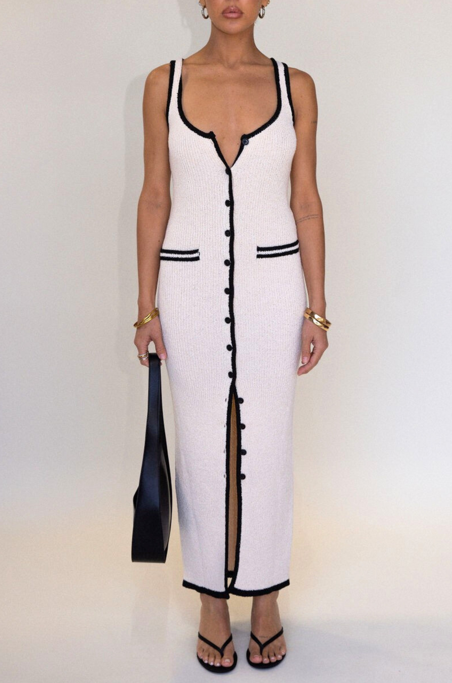 cream Crochet knit maxi dress. Sleeveless. V-neckline. Front button down closures. Faux front pockets. Unlined. cream knit maxi dress. knit button down maxi dress