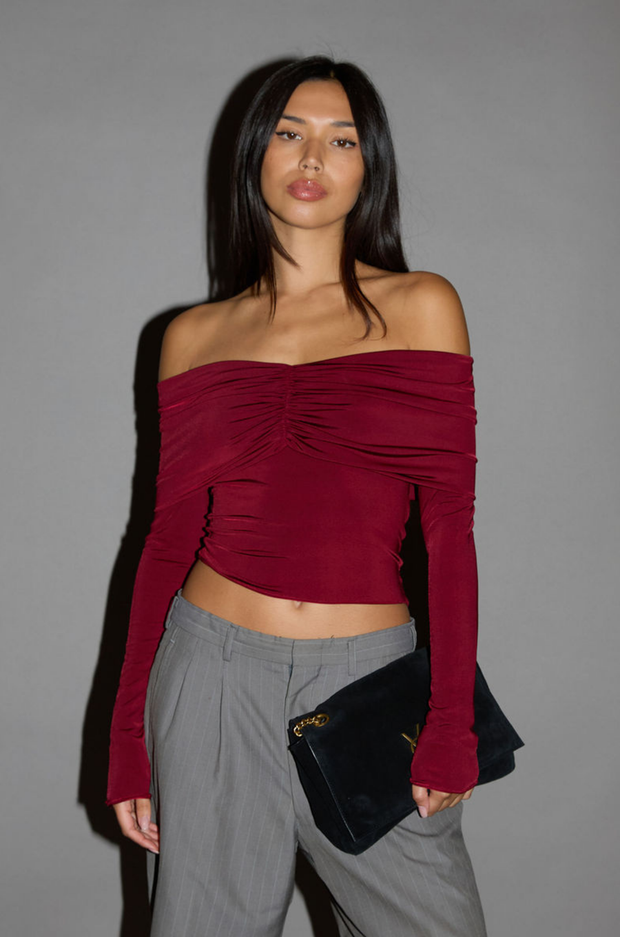 Knit crop top. Strapless elastic folded neckline. Front and back ruching. Long sleeves. Unlined. red off the shoulder long sleeve top. burgundy off the shoulder long sleeve top. holiday outfit. holiday look. christmas top. christmas outfit