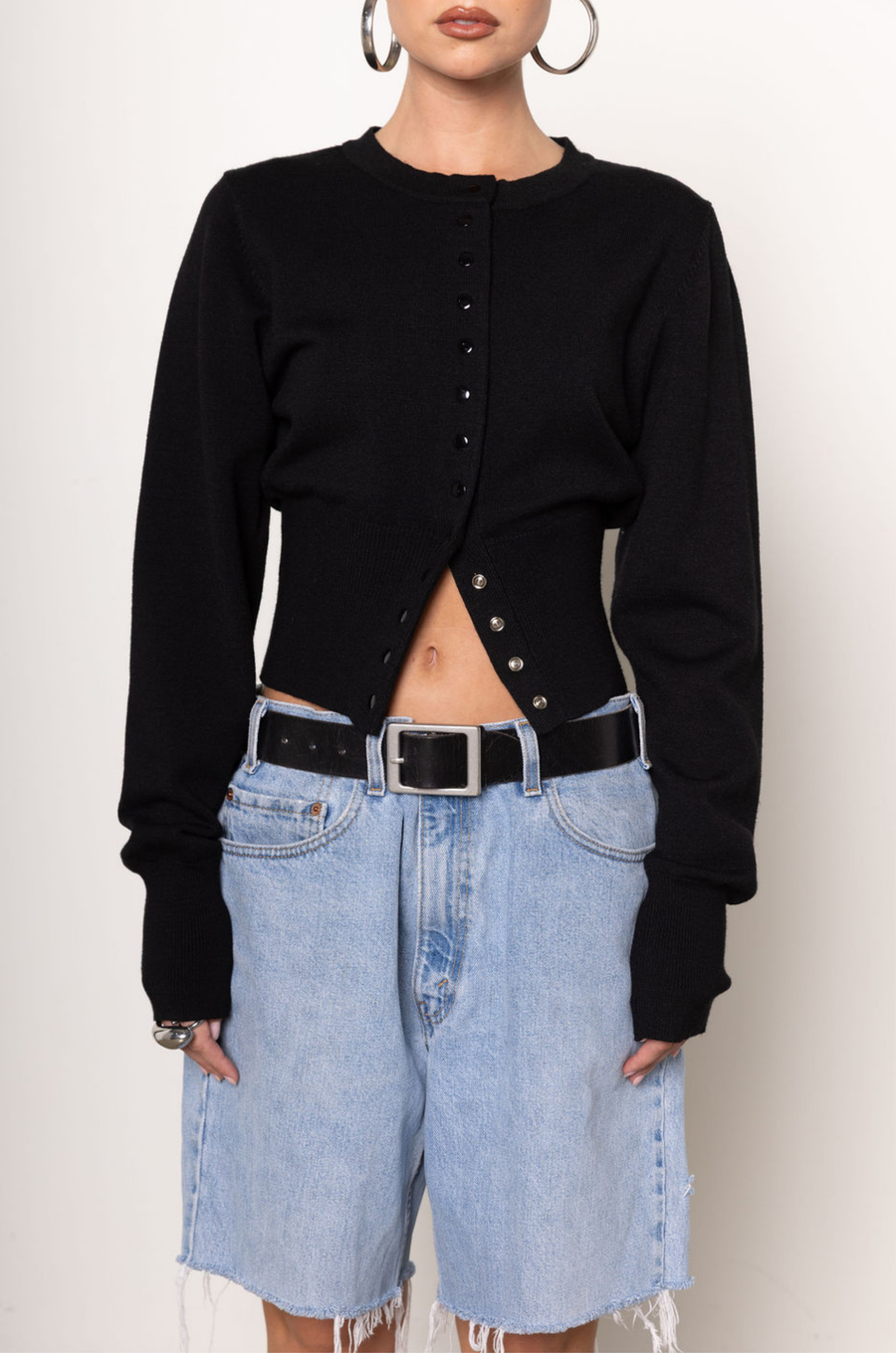 Black knit cardigan. Long sleeves. Front button down closure. Banded hems. Unlined. fall top. fall outfit. holiday outfit.