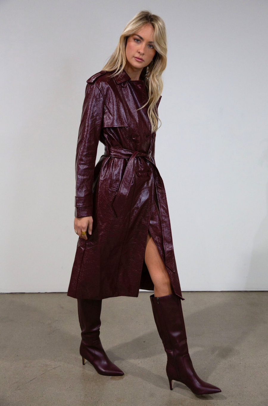 Faux leather trench coat. Collar neckline. Double breasted. Front button closures. Belted waist. Side pockets. Fully lined. burgundy faux leather trench coat. fall outfit. fall trench coat