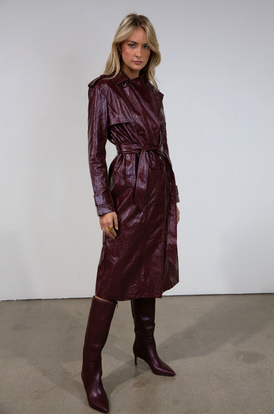 Faux leather trench coat. Collar neckline. Double breasted. Front button closures. Belted waist. Side pockets. Fully lined. burgundy faux leather trench coat. fall outfit. fall trench coat
