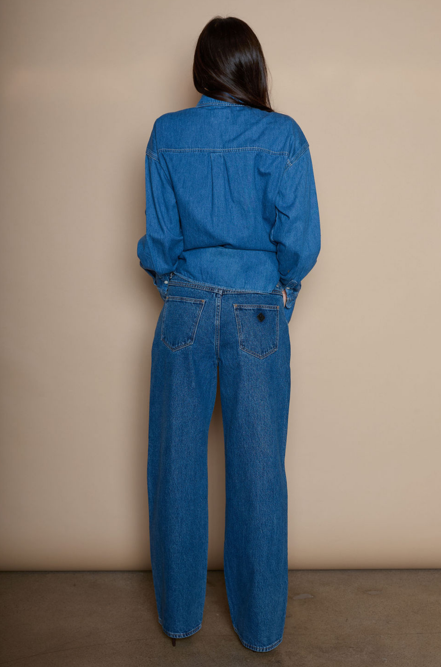 Mid rise straight leg jeans. Relaxed fit. Button and zipper fly. Five pocket construction. medium wash denim jeans