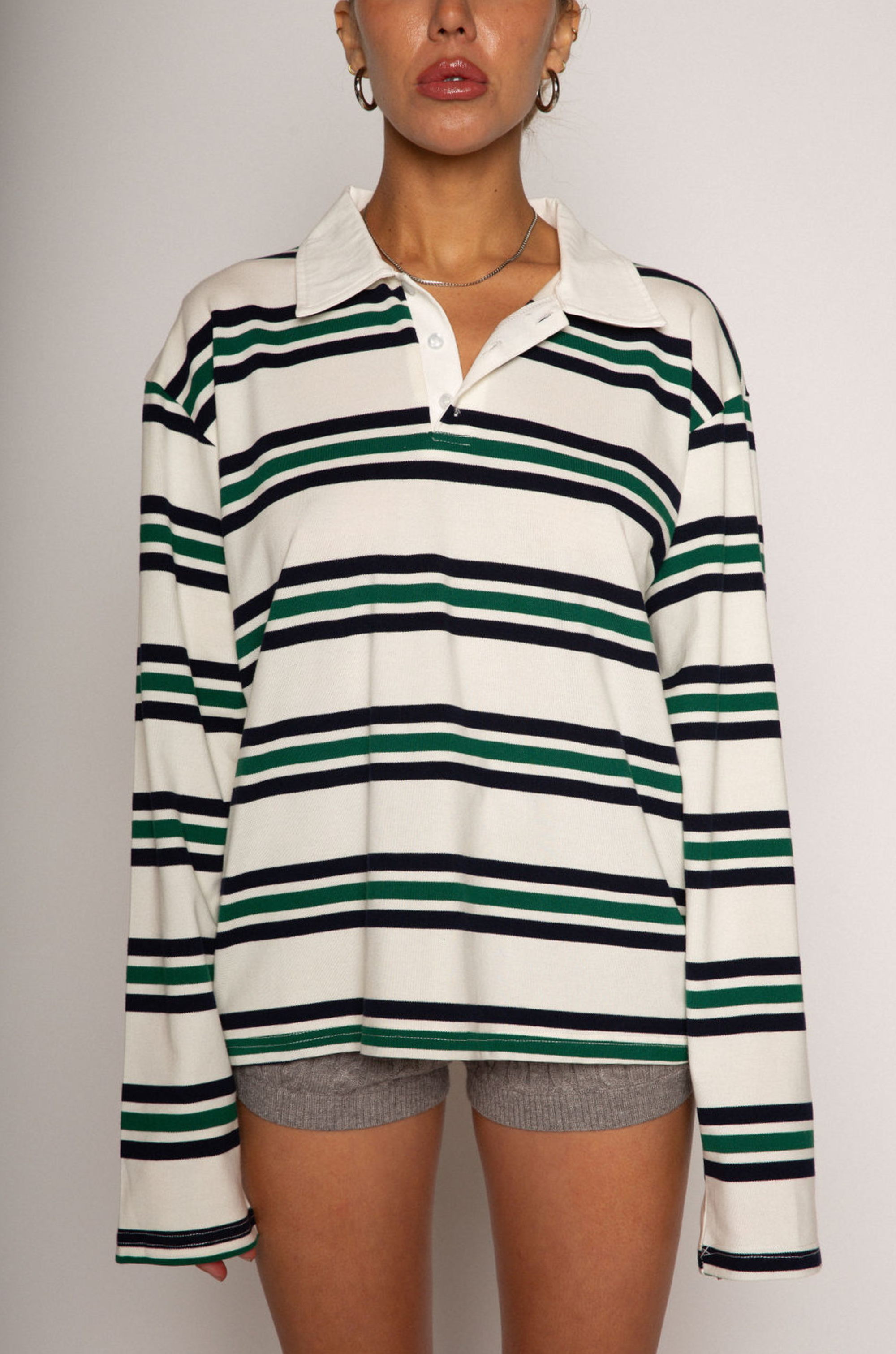 Striped knit top. Collar neckline. Front button closures. Long sleeves. Unlined. striped polo long sleeve. fall top. fall outfit