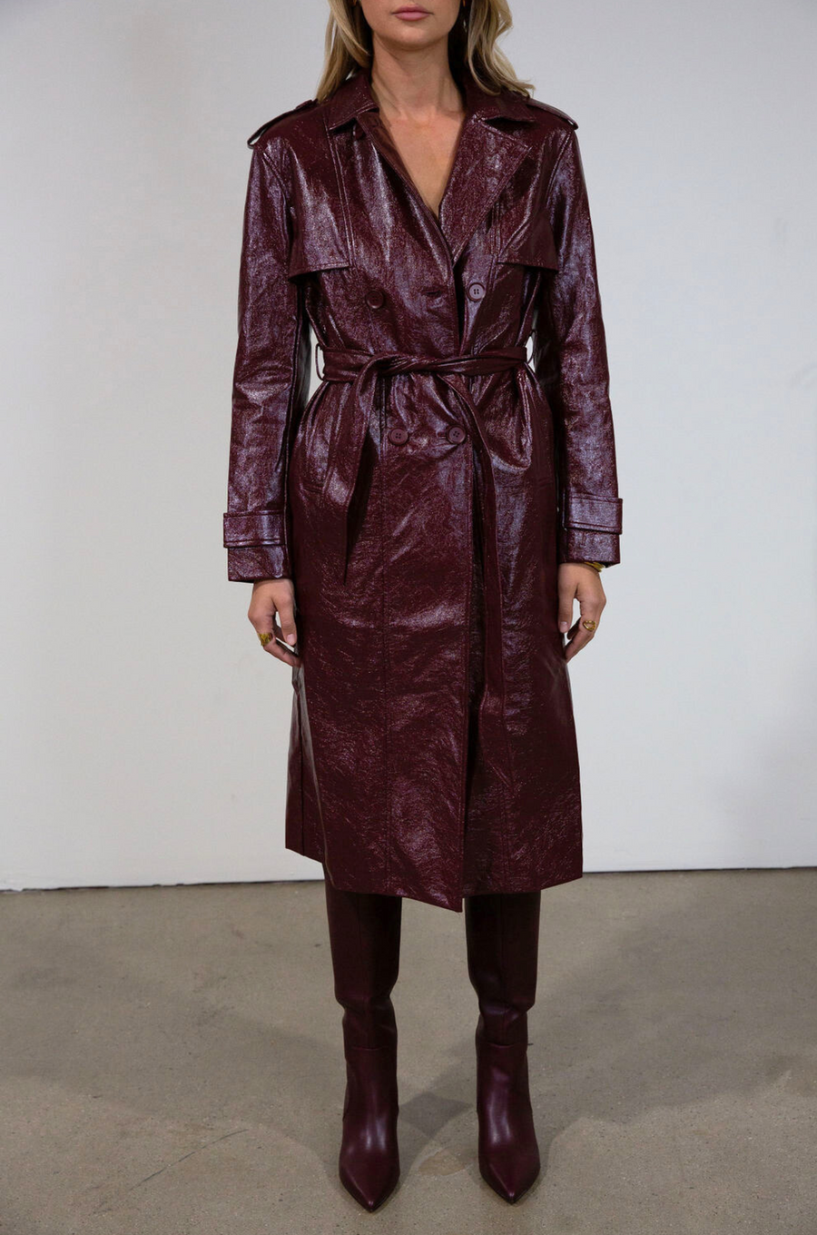 Faux leather trench coat. Collar neckline. Double breasted. Front button closures. Belted waist. Side pockets. Fully lined. burgundy faux leather trench coat. fall outfit. fall trench coat