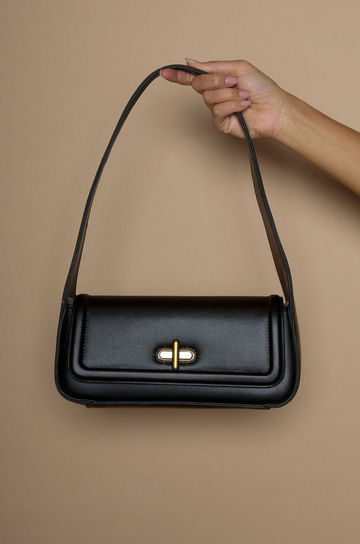 Vegan leather bag. Fixed top strap. Front twist latch closure. Fully lined. Inner pockets.&nbsp;