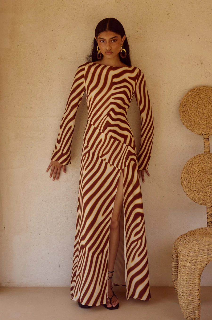 Animal printed long sleeve maxi dress
Front high slit 
Boat neckline
Adjustable back straps 
Open back Back zipper closure 
Lined, non-stretch 
zebra printed maxi dress 
long sleeve maxi dress