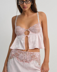 Pink satin sleep lingerie top
Open-front satin cami tank top
Sleek floral jacquard,
Adorned with lace trims, decorative bows, and a rosette at the center-front
Adjustable shoulder straps
Hook and eye closure at center-back
Unlined
Polyester/Elastane
