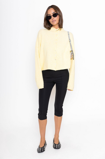 Fuzzy knit cardigan
Crewneck
Front button down closures
Long sleeves
Unlined
yellow cardigan